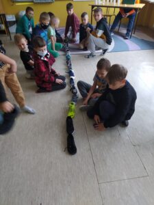 Zdjęcie przedstawia uczniów wróżących z butów